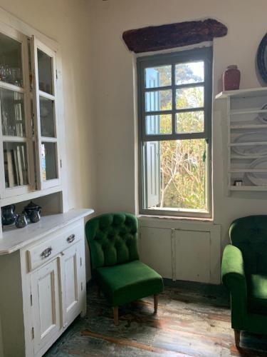 a room with a green chair and a window at Villa Katina in Arethousa