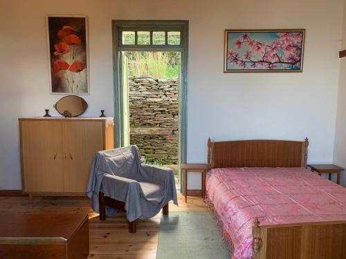 a bedroom with a bed and a door with a window at Villa Katina in Arethousa