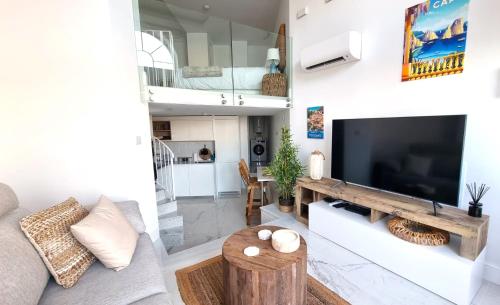a living room with a large flat screen tv at New beachfront duplex - sleeps up to 4 in Gibraltar