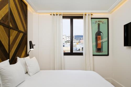 a bedroom with a bottle of wine on the window at Praktik Vinoteca in Barcelona