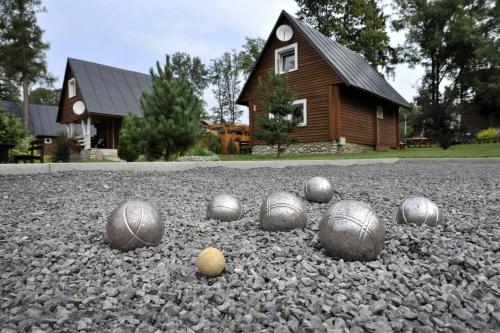 a group of balls on the ground in front of a house at APLEND Villas Tatry Holiday in Veľký Slavkov