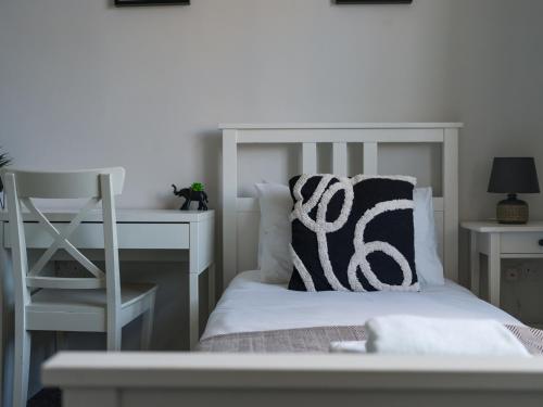 a white bed with a white desk and a pillow at Lilys Apartment 2- 2bedroom, Northumberland in Bedlington