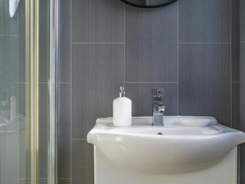 a bathroom with a white sink and a mirror at Lilys Apartment 2- 2bedroom, Northumberland in Bedlington