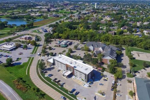 an aerial view of a building with a parking lot at La Quinta by Wyndham Des Moines West Clive in Clive