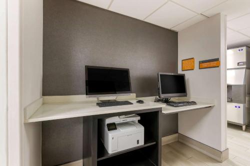 an office with two computers on a desk at La Quinta by Wyndham Des Moines West Clive in Clive