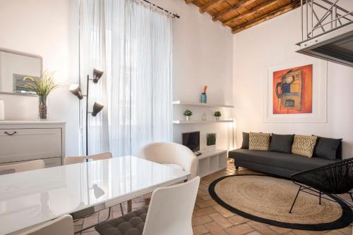 a living room with a table and a couch at Imperial Loft in Rome