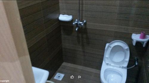 a bathroom with a toilet and a sink at Prime View Hotel in Faisalabad