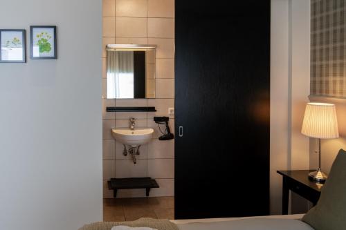 a bathroom with a sink and a mirror at HOTEL SNAEFELLSNES formally Hotel Rjukandi in Vegamót
