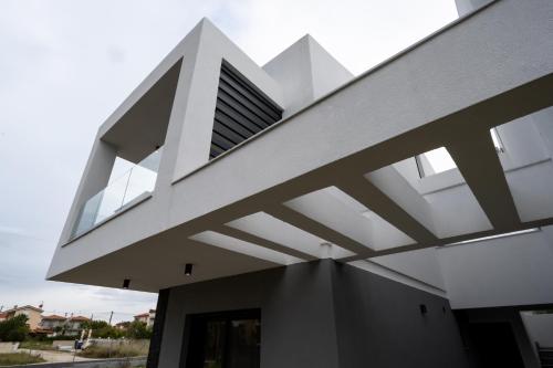 a modern house with a white facade at IRIS SUITES NIKITI in Nikiti