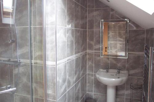 a bathroom with a sink and a shower at Thornthwaite Farm in Broughton in Furness