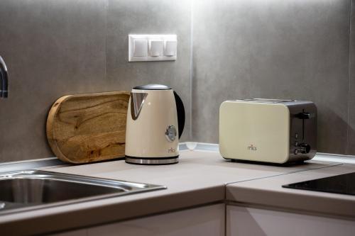 a kitchen with two toasters sitting on a counter at IRIS SUITES NIKITI in Nikiti