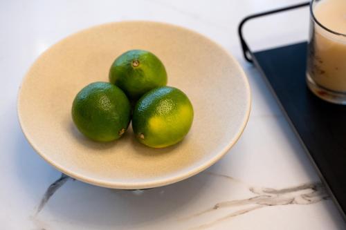a white bowl with three limes on a table at IRIS SUITES NIKITI in Nikiti