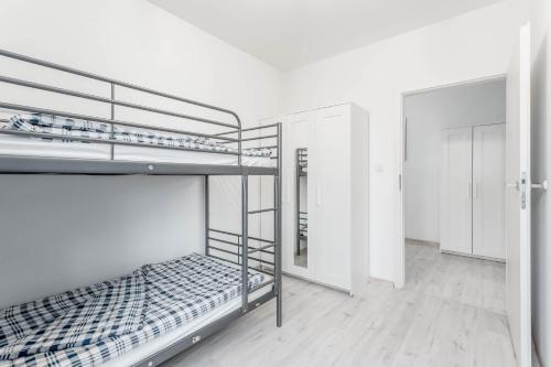 a room with two bunk beds in it at Chill Apartments Bociania in Warsaw