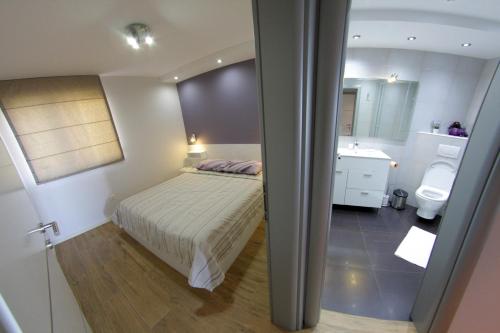 a small bedroom with a bed and a bathroom at Villa Nena in Makarska