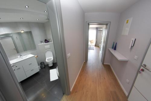 a bathroom with a sink and a toilet and a mirror at Villa Nena in Makarska