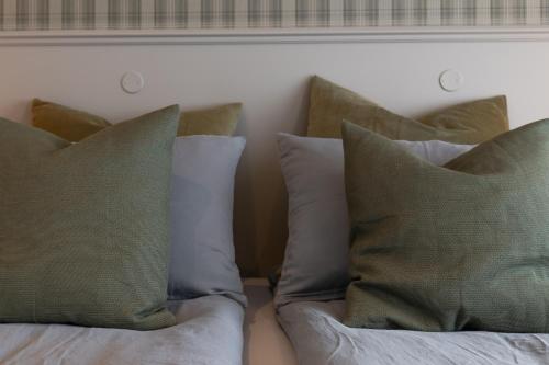 a couple of pillows sitting on top of a bed at HOTEL SNAEFELLSNES formally Hotel Rjukandi in Vegamót