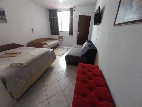 a small room with two beds and a couch at Apto JOSENINOS in Campos dos Goytacazes
