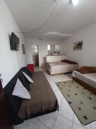 a living room with two beds and a couch at Apto JOSENINOS in Campos dos Goytacazes