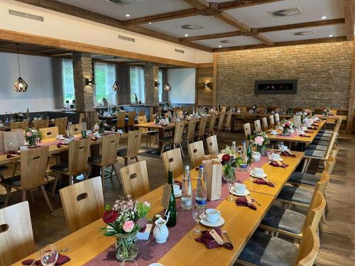 a dining room with long tables and chairs at Hotel Gasthof zum Wulfen in Sulzbach-Rosenberg