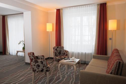 a living room with a couch and chairs and a table at Hotel Bayerischer Hof Miesbach, BW Premier Collection in Miesbach