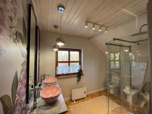 a bathroom with a glass shower and a sink at Przystanek Jeziorna 49 in Perlino
