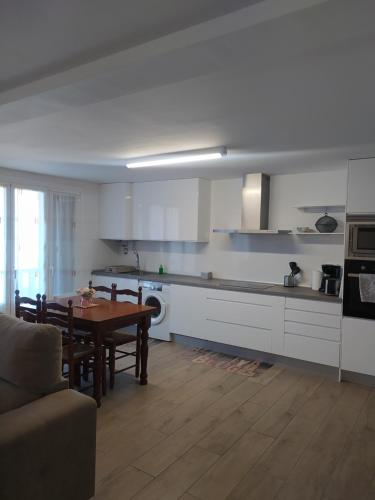 a kitchen with a table and a dining room at Apartamento Beretaberri in Narvarte