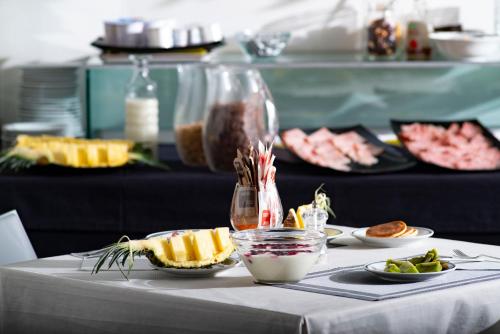a table topped with plates of food on a table at Hotel Nuova Mestre in Mestre
