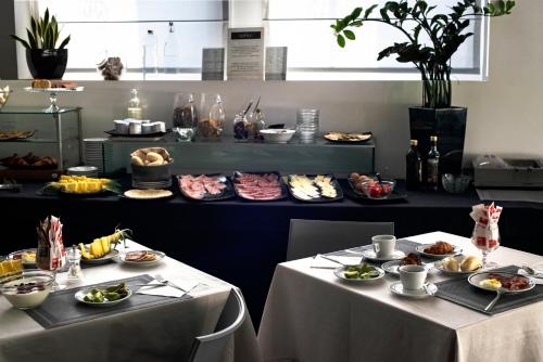 two tables with plates of food on them at Hotel Nuova Mestre in Mestre