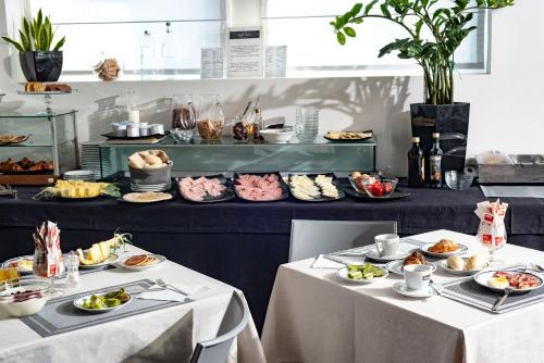 two tables with plates of food on them at Hotel Nuova Mestre in Mestre