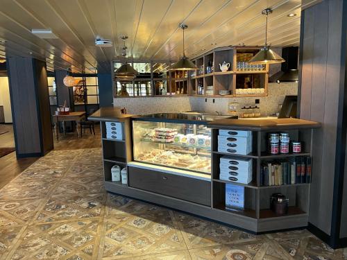 a bakery with a display case in a restaurant at Skogstad Hotel in Hemsedal