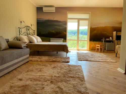 a living room with a couch and a sliding glass door at Гостьовий двір РіОНІ in Truskavets