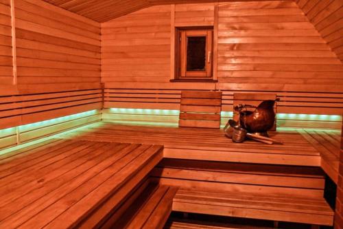 a sauna with a cat sitting on the inside of it at Gerovės sodybėlė in Garliava