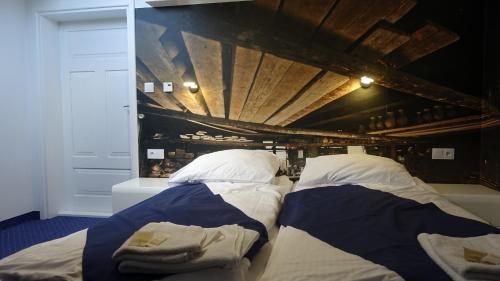 a room with two beds in a room with wine bottles at Janowski Zakątek in Janów Lubelski