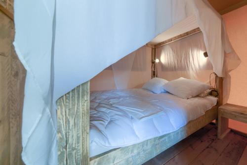 a bedroom with a bed with a canopy at Glamping -Bungalows El Faro in Conil de la Frontera