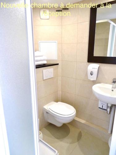 a bathroom with a toilet and a sink at Première Classe Troyes Sud - Buchères in Troyes