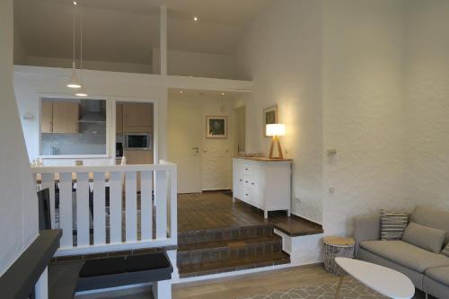 a living room with a couch and a kitchen at Landhaus 906 in Biersdorf