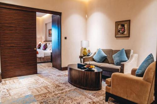 a living room with a couch and a table at Warwick Al Khobar in Al Khobar