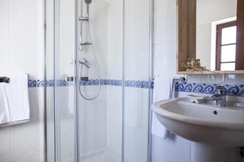 a bathroom with a sink and a shower at Refúgio do Monte in Odemira