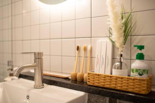 a bathroom counter with a sink and a basket with toiletries at Stay Hwangchon in Gyeongju