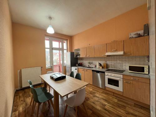 a kitchen with a wooden table with chairs and a tableasteryasteryasteryasteryastery at Family Apartments Thale in Thale