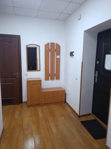 a room with a door and a mirror on a wall at Apartments Domovik on Valenberga 3 in Mukacheve