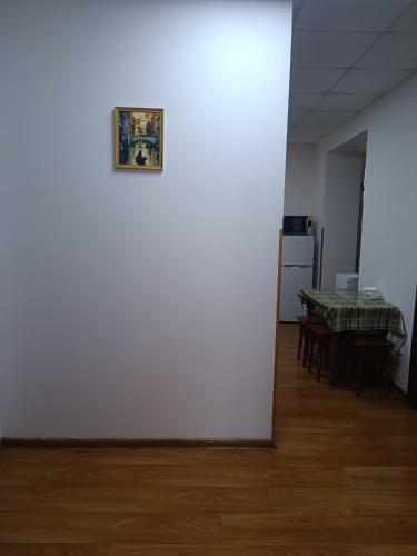 a room with a table and a picture on the wall at Apartments Domovik on Valenberga 3 in Mukacheve