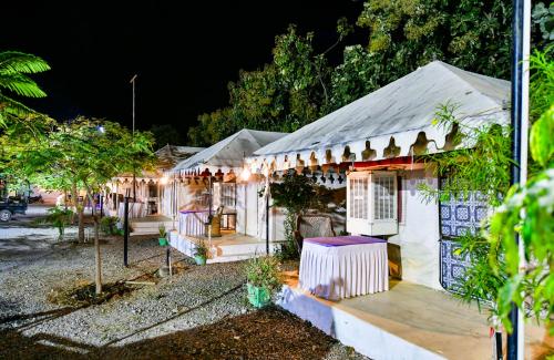 a house with lights on it at night at HARIYALI RESORT in Sardārgarh