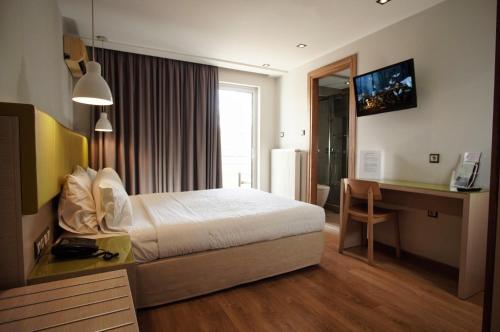 a hotel room with a bed and a desk at Elements Rooms & Apartments in Athens