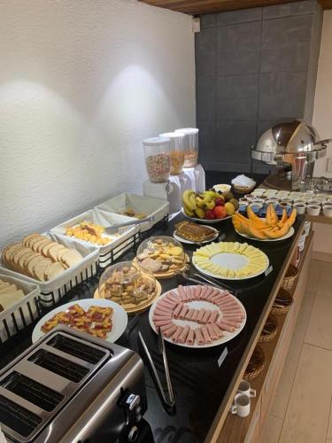 a kitchen with many plates of food on a counter at Hotel Bahia in La Paloma