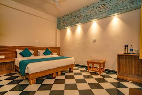 a bedroom with a bed and a checkered floor at The Uddhav Elite in Udaipur