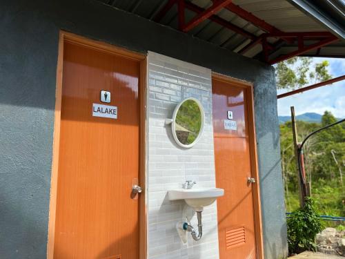 a bathroom with a sink and a door at Casa Escala in Gingoog