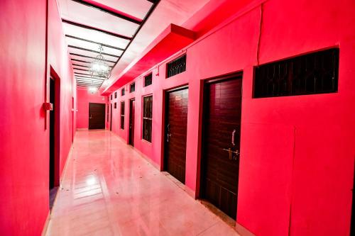 a hallway with red walls and wooden doors at HARIYALI RESORT in Sardārgarh