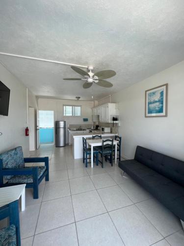 a living room with a couch and a ceiling fan at Nautilus Ocean Suites in Bridgetown