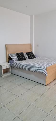 a bed in a bedroom with a white floor at Eagle nest 2 in Nairobi